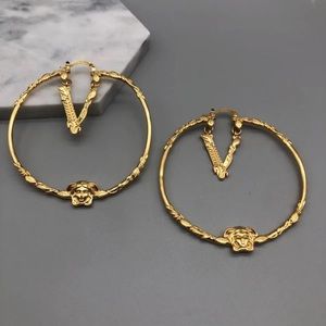 Brand new Versace earrings come with case and dust bag and tote bag.